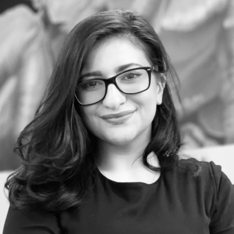 A black and white photo of Ilianna, a woman with long dark hair and glasses.